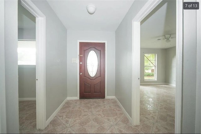 12911 Slater Ln, Houston, TX 77039 - foyer entrance featuring light tile patterned floors and baseboards
