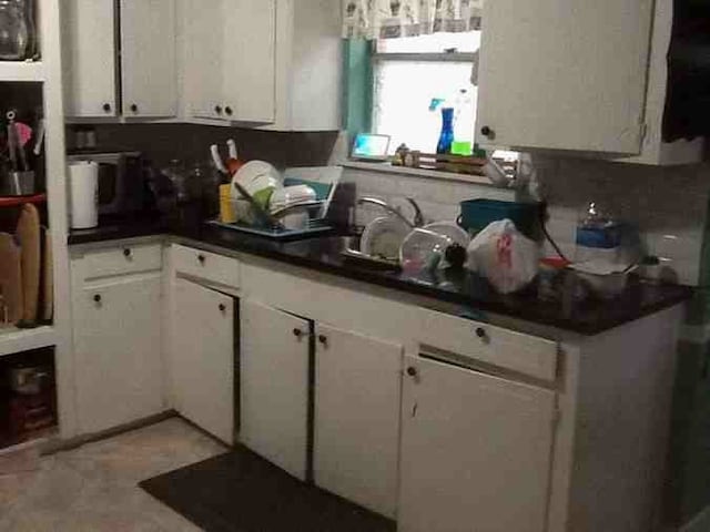 12911 Slater Ln, Houston, TX 77039 - kitchen with white cabinetry and dark countertops