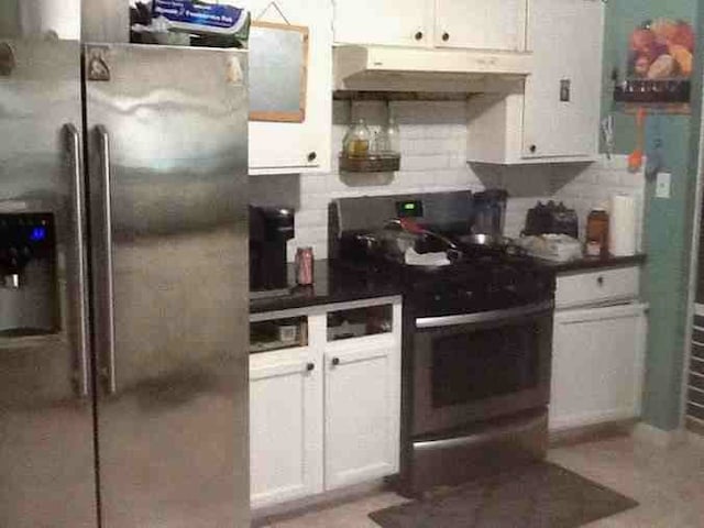 12911 Slater Ln, Houston, TX 77039 - kitchen with appliances with stainless steel finishes, under cabinet range hood, decorative backsplash, and white cabinets