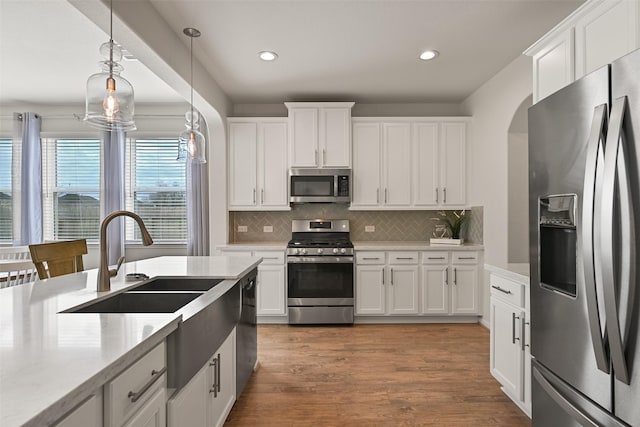1838 Alyssa Way, Alvin, TX 77511 - kitchen featuring stainless steel appliances, recessed lighting, decorative backsplash, white cabinetry, and arched walkways