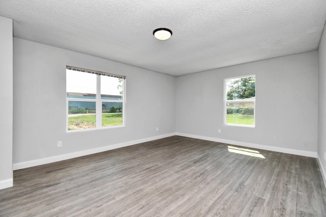 1030 San Felipe Rd, Sealy, TX 77474 - spare room with a textured ceiling and wood finished floors