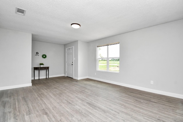 1030 San Felipe Rd, Sealy, TX 77474 - empty room featuring wood finished floors and a textured ceiling