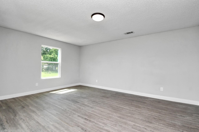 1030 San Felipe Rd, Sealy, TX 77474 - spare room with wood finished floors and a textured ceiling