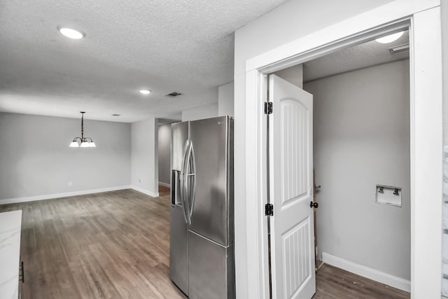 1030 San Felipe Rd, Sealy, TX 77474 - kitchen featuring stainless steel fridge, a textured ceiling, wood finished floors, and decorative light fixtures