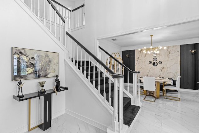 4814 Kirkwall Dr, Sugar Land, TX 77479 - staircase featuring marble tiled flooring, a chandelier, and ornamental molding
