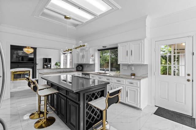 4814 Kirkwall Dr, Sugar Land, TX 77479 - kitchen with white cabinets, crown molding, light marble finish floors, light stone countertops, and a fireplace