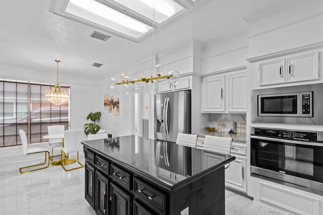 4814 Kirkwall Dr, Sugar Land, TX 77479 - kitchen with stainless steel appliances, a chandelier, dark cabinetry, light marble finish floors, and hanging light fixtures