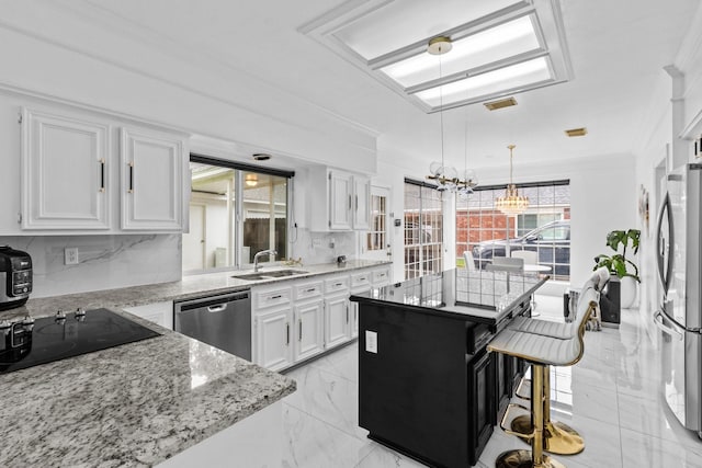 4814 Kirkwall Dr, Sugar Land, TX 77479 - kitchen with stainless steel appliances, white cabinetry, a chandelier, decorative backsplash, and ornamental molding