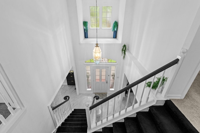 4814 Kirkwall Dr, Sugar Land, TX 77479 - stairway with a towering ceiling and marble look tile flooring
