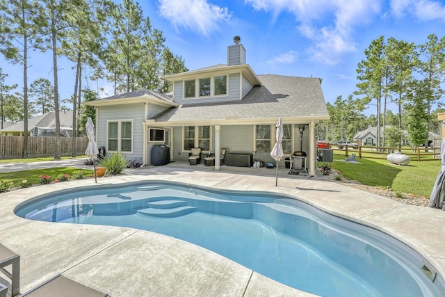 16413 Stonewall St, Conroe, TX 77303 - rear view of property with a patio, a chimney, and a shingled roof