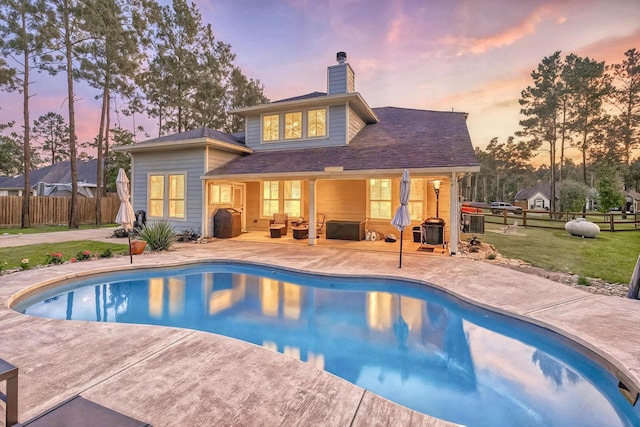 16413 Stonewall St, Conroe, TX 77303 - back of property featuring a patio area, a chimney, and outdoor lounge area