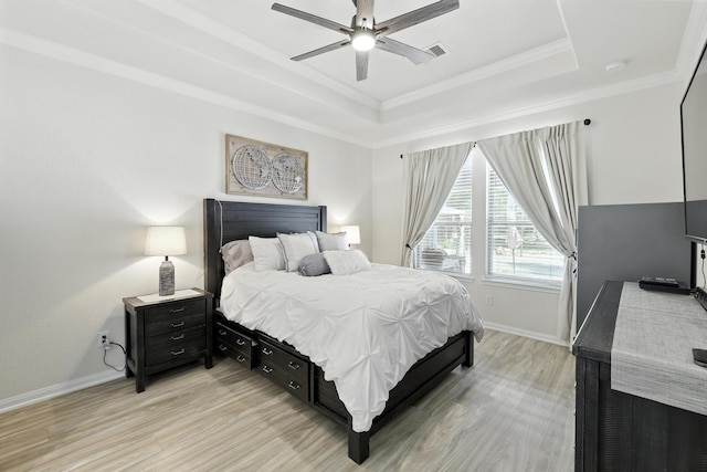 16413 Stonewall St, Conroe, TX 77303 - bedroom featuring a tray ceiling, light wood-style floors, crown molding, and ceiling fan
