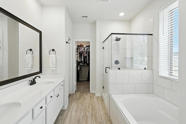 16413 Stonewall St, Conroe, TX 77303 - bathroom with a bath, a shower stall, plenty of natural light, double vanity, and recessed lighting