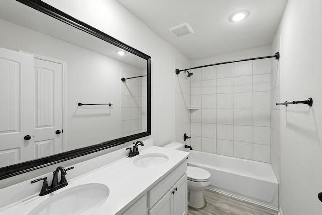 16413 Stonewall St, Conroe, TX 77303 - full bathroom featuring double vanity, wood finished floors, and washtub / shower combination