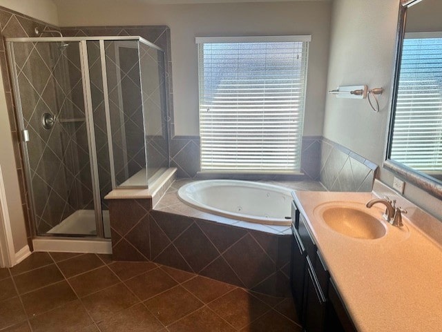 19522 Brighton Brook Ln, Richmond, TX 77407 - full bathroom featuring vanity, a jetted tub, a stall shower, and tile patterned floors