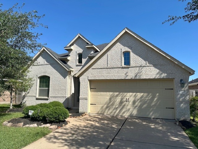 19522 Brighton Brook Ln, Richmond, TX 77407 - view of front of house with brick siding, a garage, and concrete driveway