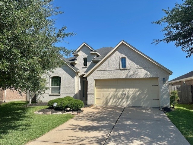 19522 Brighton Brook Ln, Richmond, TX 77407 - view of front of home featuring concrete driveway, an attached garage, and brick siding