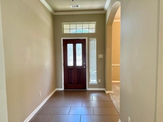 19522 Brighton Brook Ln, Richmond, TX 77407 - foyer with arched walkways, ornamental molding, and dark tile patterned floors