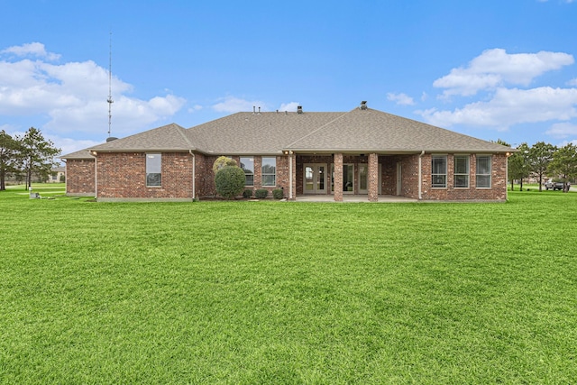 4606 Silhouette Dr, Katy, TX 77493 - rear view of house with a patio area, a yard, a shingled roof, and brick siding