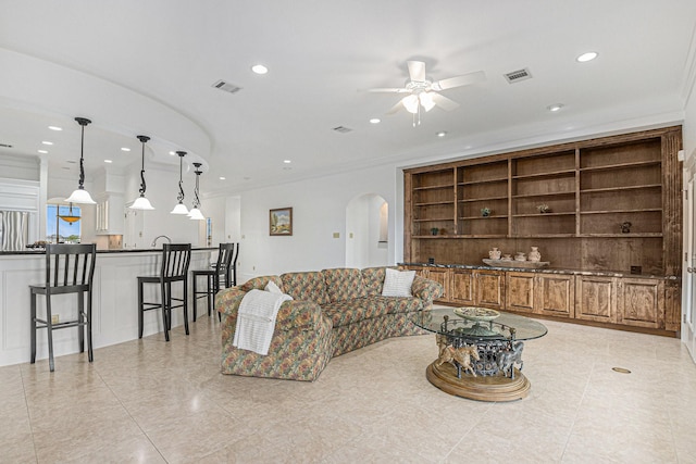 4606 Silhouette Dr, Katy, TX 77493 - living area featuring arched walkways, ceiling fan, recessed lighting, and crown molding