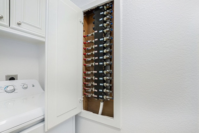 4606 Silhouette Dr, Katy, TX 77493 - laundry room featuring washer / dryer and a textured wall
