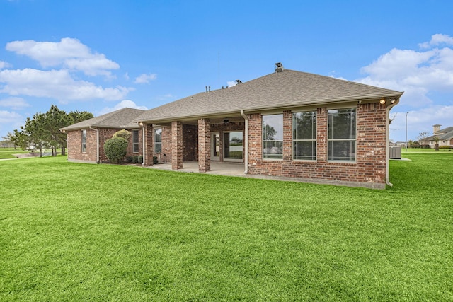 4606 Silhouette Dr, Katy, TX 77493 - rear view of property with a patio, a lawn, roof with shingles, and brick siding