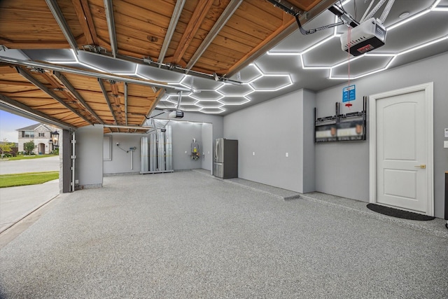 631 Rita Blanca Dr, Webster, TX 77598 - garage with a garage door opener and freestanding refrigerator