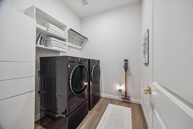 631 Rita Blanca Dr, Webster, TX 77598 - laundry room featuring washer and clothes dryer and wood finished floors