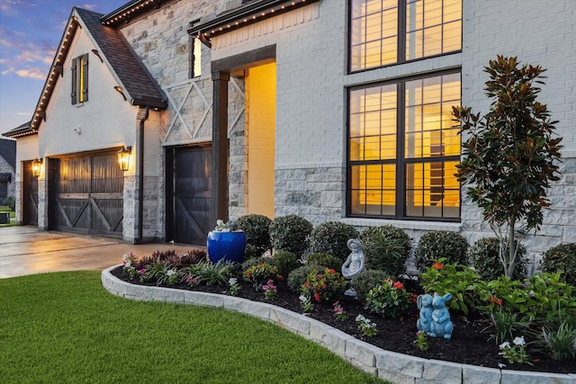 631 Rita Blanca Dr, Webster, TX 77598 - view of front of house with a garage, stone siding, driveway, and a front lawn