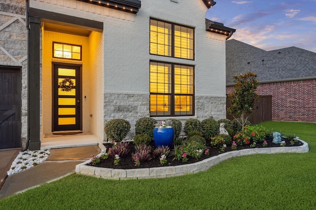 631 Rita Blanca Dr, Webster, TX 77598 - exterior entry at dusk featuring brick siding and stone siding