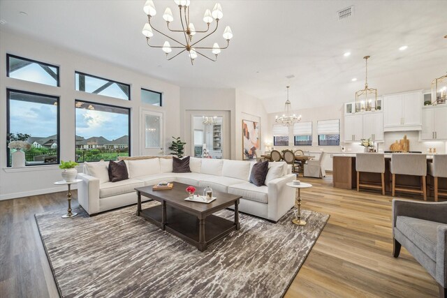631 Rita Blanca Dr, Webster, TX 77598 - living area featuring a chandelier, light wood-type flooring, and recessed lighting