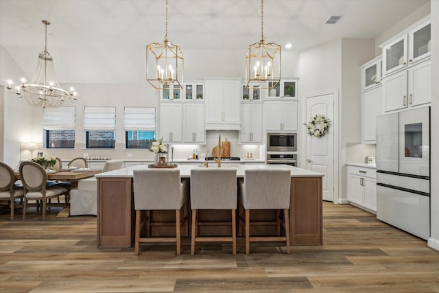 631 Rita Blanca Dr, Webster, TX 77598 - kitchen featuring a chandelier, stainless steel appliances, light countertops, recessed lighting, and a towering ceiling