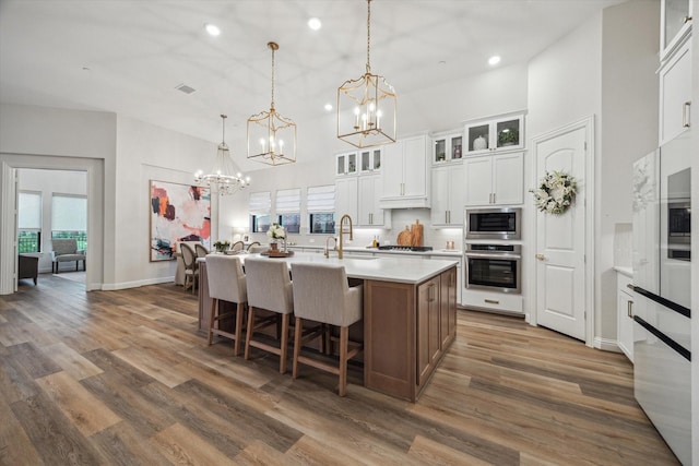 631 Rita Blanca Dr, Webster, TX 77598 - kitchen featuring appliances with stainless steel finishes, a chandelier, an island with sink, recessed lighting, and a high ceiling
