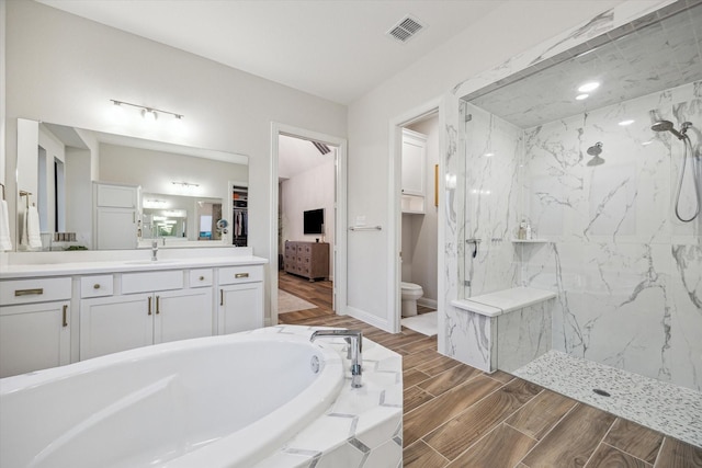 631 Rita Blanca Dr, Webster, TX 77598 - full bathroom featuring a marble finish shower, vanity, a bath, and wood tiled floors