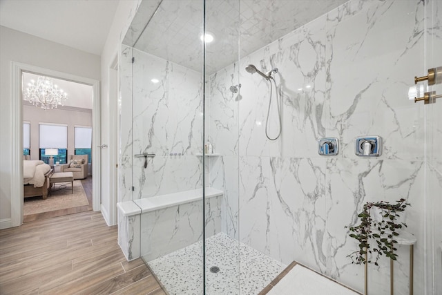 631 Rita Blanca Dr, Webster, TX 77598 - bathroom featuring connected bathroom, a marble finish shower, a chandelier, and wood finished floors