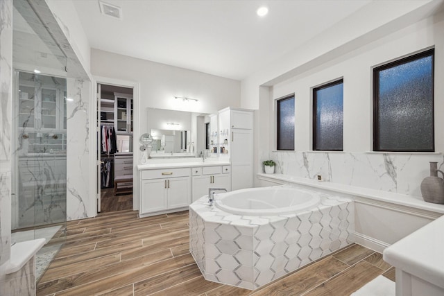 631 Rita Blanca Dr, Webster, TX 77598 - full bathroom with a bath, vanity, wood tiled floors, a marble finish shower, and a spacious closet