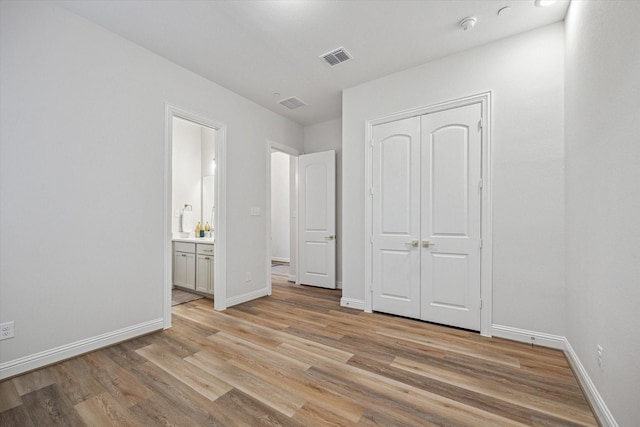 631 Rita Blanca Dr, Webster, TX 77598 - unfurnished bedroom featuring light wood-type flooring, a closet, and ensuite bathroom