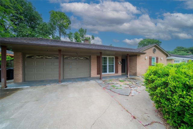 7602 Jackwood St, Houston, TX 77074 - ranch-style house featuring brick siding, a garage, concrete driveway, and a chimney