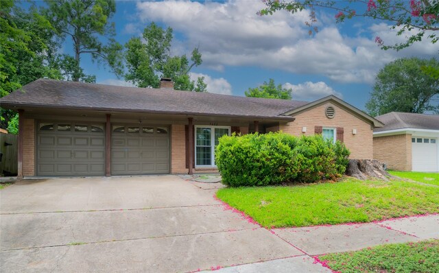 7602 Jackwood St, Houston, TX 77074 - ranch-style home featuring a garage, concrete driveway, brick siding, a chimney, and a front lawn