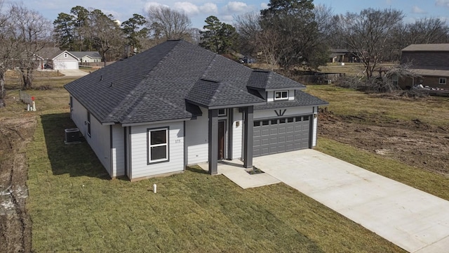 175 Deep Woods Ln, Livingston, TX 77351 - view of front of home featuring roof with shingles, a front yard, and concrete driveway