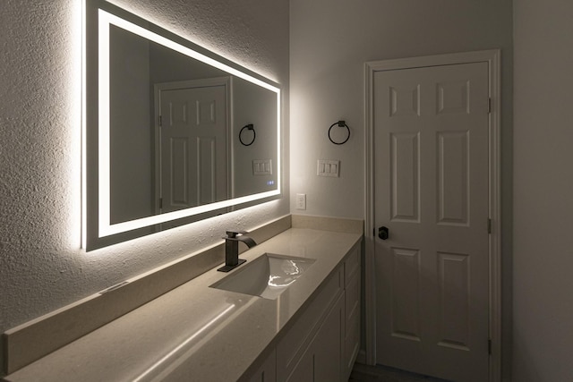 175 Deep Woods Ln, Livingston, TX 77351 - bathroom featuring a textured wall and vanity