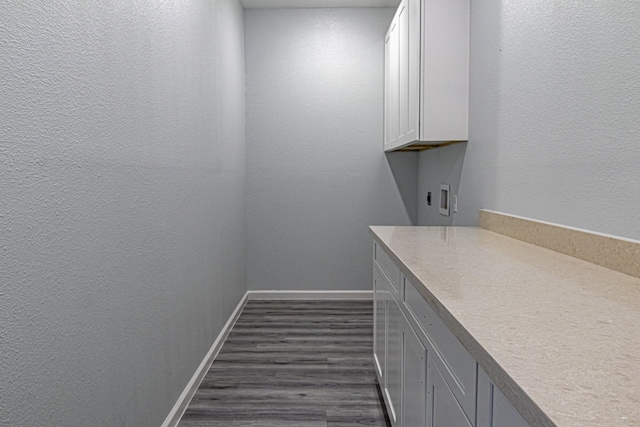 175 Deep Woods Ln, Livingston, TX 77351 - laundry room featuring cabinet space, dark wood-type flooring, a textured wall, hookup for an electric dryer, and hookup for a washing machine