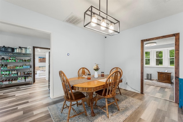 703 Pecan Valley Dr, Wharton, TX 77488 - dining room featuring wood finished floors and a chandelier