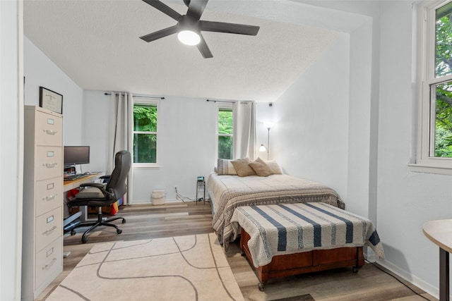 703 Pecan Valley Dr, Wharton, TX 77488 - bedroom featuring a desk, a textured ceiling, wood finished floors, and a ceiling fan