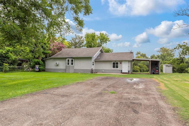 703 Pecan Valley Dr, Wharton, TX 77488 - single story home featuring a front yard, a shed, driveway, and a carport