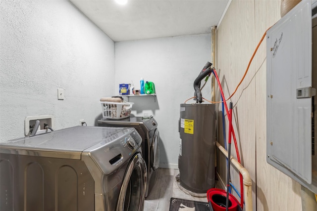 703 Pecan Valley Dr, Wharton, TX 77488 - laundry room featuring water heater, washer and dryer, wood finished floors, and electric panel
