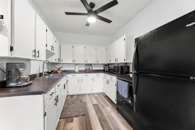 703 Pecan Valley Dr, Wharton, TX 77488 - kitchen featuring black appliances, dark countertops, light wood-style flooring, ceiling fan, and white cabinets