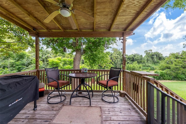 703 Pecan Valley Dr, Wharton, TX 77488 - wooden terrace featuring a ceiling fan, area for grilling, and view of wooded area