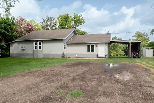 703 Pecan Valley Dr, Wharton, TX 77488 - back of property with a shingled roof, a yard, and an AC wall unit