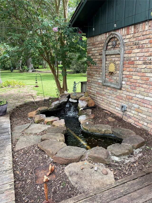 507 Oak Dr, Lake Jackson, TX 77566 - view of patio / terrace with a small pond